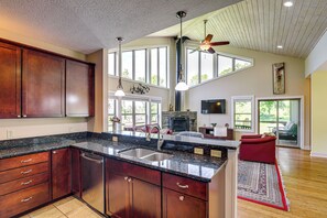 A spacious kitchen with a large island, wooden cabinets, and a built-in dishwasher. - Asheville Mountain Hideaway, 6 Mi to Dtwn (Asheville)
