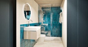 Une salle de bain moderne avec une douche à parois de verre, un lavabo blanc et un miroir.