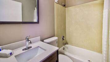 A bathroom with a sink, toilet, and bathtub.