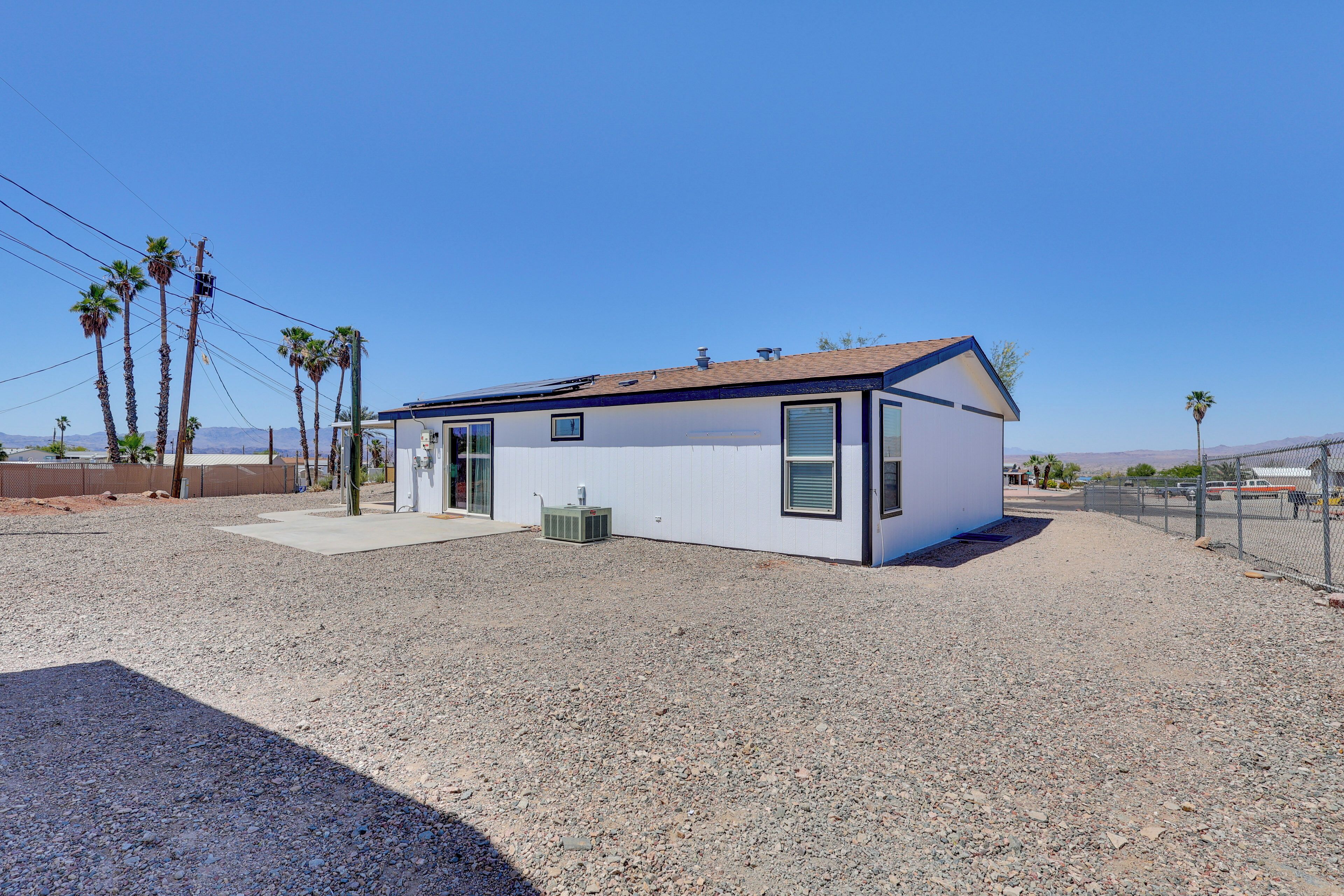 A single-story building with a flat roof, a small porch, and a gravel driveway.