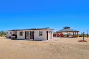 A single-story building with a covered patio area, a carport, and a small garden. - Great for Families! Mtn-View Getaway in Maricopa (Maricopa)