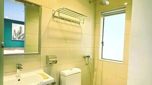 A bathroom with a sink, toilet, shower, and a towel rack. - Enclave Hotel Kuala Lumpur (Kuala Lumpur)