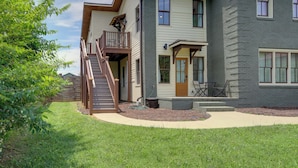 A two-story house with a balcony, a front door, and a staircase leading to the second floor. - Extended East Knoxville Stay, 2 Mi to Dtwn! (Knoxville)