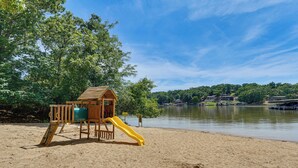 A beach with a wooden play structure and a slide. - Unwind Poolside, Walk to Beach! Ozarks Getaway (Osage Beach)