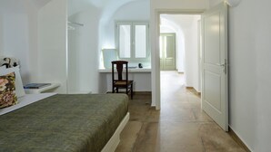 A bedroom with a bed, a desk, and a chair. - A Cycladic home with a private pool and sea view, away from the crowds! (Exo Gonia)