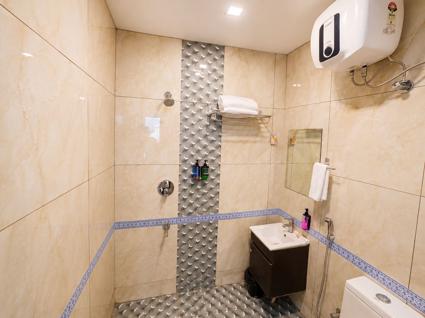 A bathroom with a shower, a sink, and a toilet.