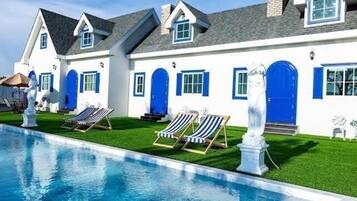Deluxe Quadruple Room, Balcony, Courtyard View | Pool | Outdoor pool