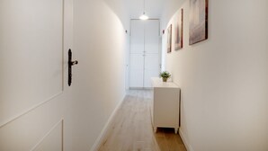 A hallway with a white door, a small white cabinet, and a pendant light. - Large studio apartment perfect for two people, is located in a shared villa but has its own private access. It features a shared garden and a large furnished patio for exclusive use. The accommodation is located in Marina di Pulsano, a well-served seasid (Marina di Pulsano)