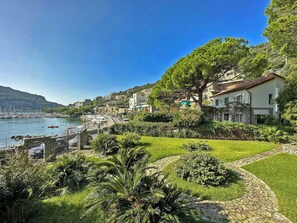 A coastal town with a marina, lush greenery, and hillside buildings. - Historic villa in Portovenere on the Gulf of Poets (Portovenere)
