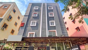 A multi-story hotel with a central staircase, multiple windows, and a reception area. - RCC Hotels Park View Inn Miyapur (Hyderabad)