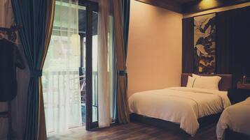 A hotel room with a bed, a nightstand, a painting, and a view through a glass door.
