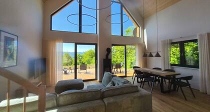 Modern wooden cottage with panoramic views, a large terrace, and air conditioning