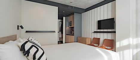 A modern bedroom with a large bed, a TV mounted on the wall, and a walk-in closet.