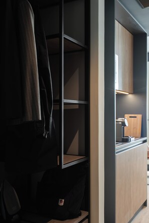 A modern kitchen with a built-in coffee machine and a wooden cutting board.
