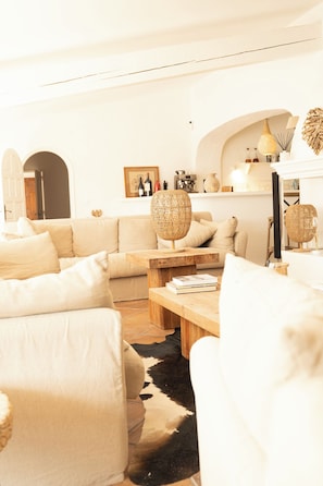 A living room with a sofa, a coffee table, and a lamp. - MAS DE DARD, Provence Estate, Heated Pool,Pickleball ans Private Lagoon,12 rooms (Saintes-Maries-de-la-Mer)