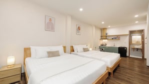 A hotel room with two beds, a small kitchenette, and a bathroom. - HAKU Boutique Hotel Da Lat - Ngo Quyen (Cam Ly - Da Lat)