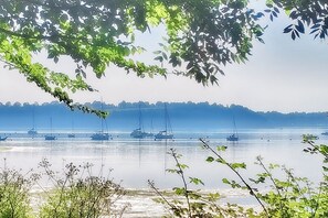 A coastal view with boats on calm water, surrounded by greenery. - Heavenly tranquility away from the crowds, yet close to everything you need to recharge and shine (Le Minihic-sur-Rance)