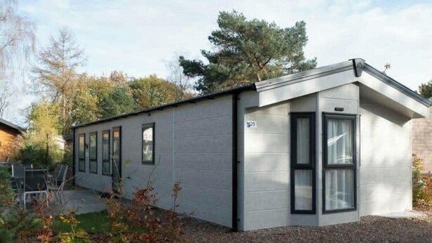 A modern single-story building with a flat roof, large windows, and a small porch area. - Holiday Home in Otterlo With Terrace (Otterlo)