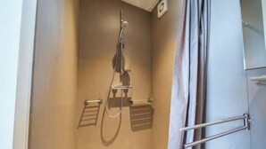 A shower with a handheld showerhead, a wall-mounted faucet, and a towel rack. - Holiday Home in Otterlo With Terrace (Otterlo)