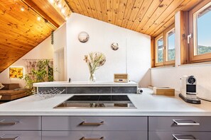A modern kitchen with a central island, a built-in sink, and a window with a view of the outdoors.