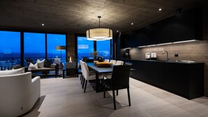 Una cocina moderna con una isla grande, un comedor con vistas y una zona de estar acogedora.
