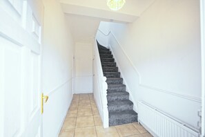 A staircase with a white handrail and a door on the left. - Upscale 3 BDR Modern Home in Anfield Liverpool (Liverpool)