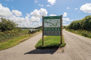 A signboard for The Camel Trail with a map and Code of Conduct.