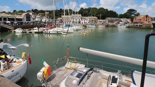 A marina with boats docked, a bridge, and buildings in the background. - Stowaway Cottage (Padstow)