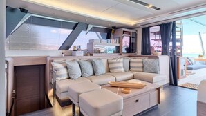 Ein modernes Interieur mit einer Couch, Poufs und einem Couchtisch.
