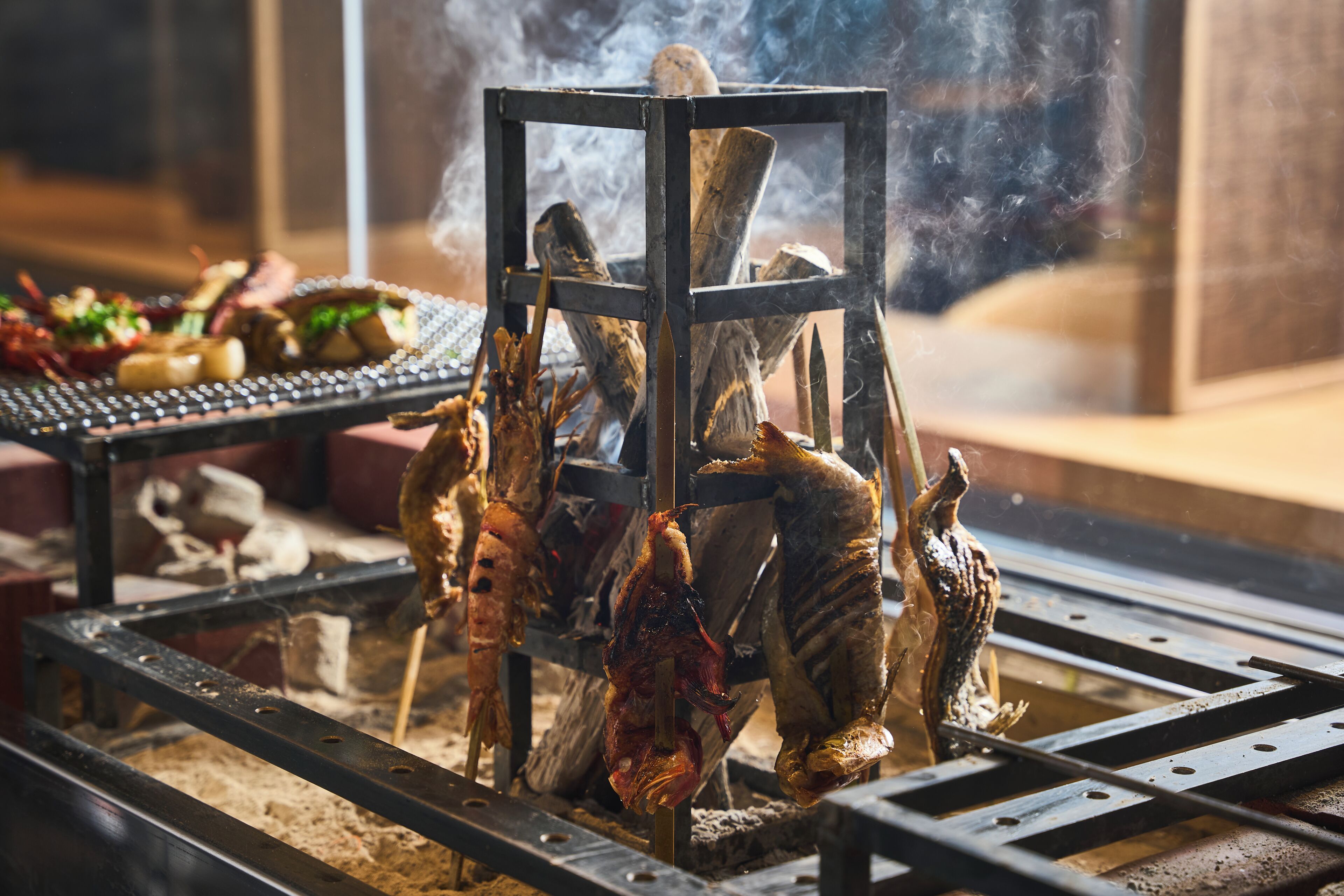 A grill with various meats being cooked.