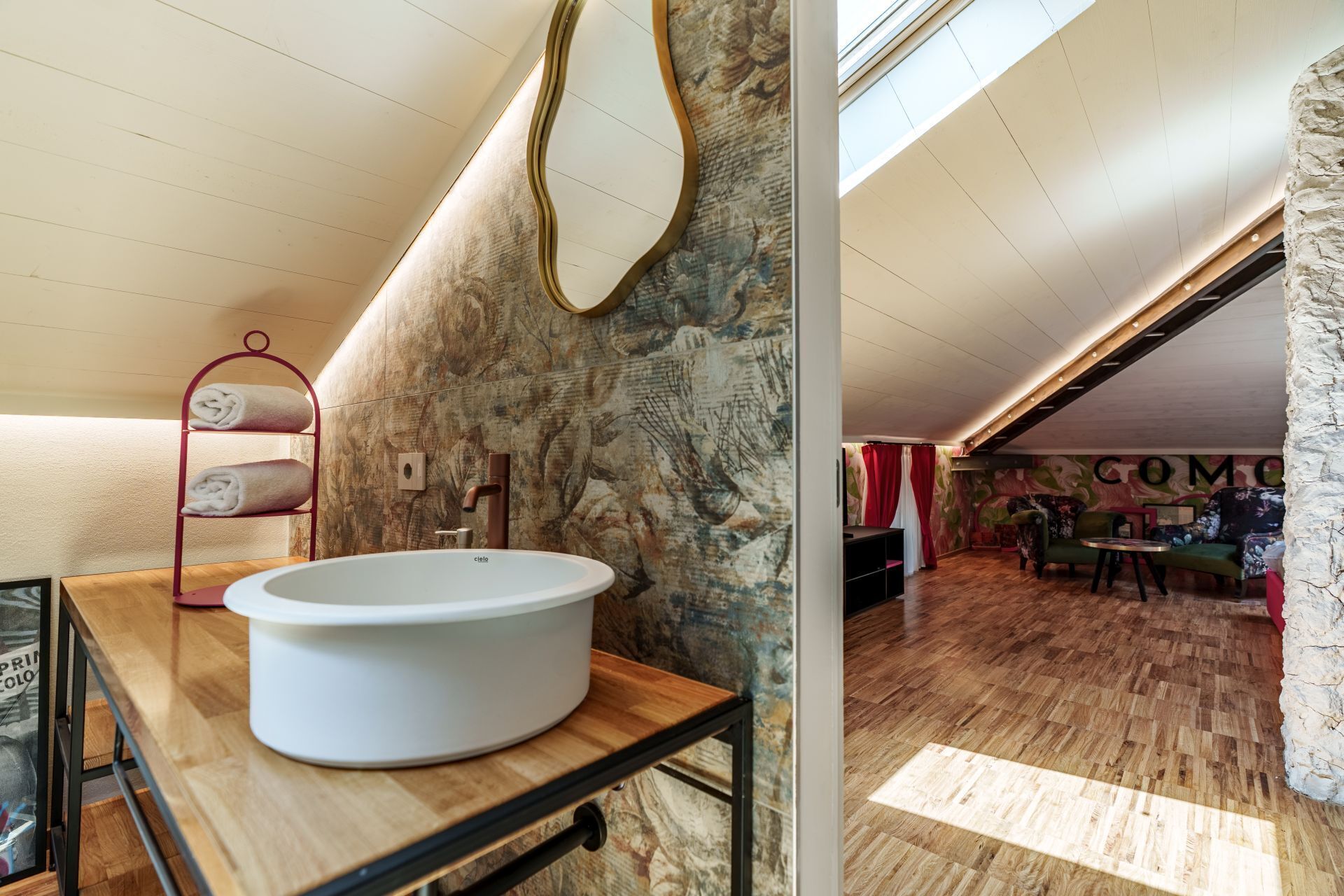 A bathroom with a freestanding bathtub, a towel rack, and a mirror.