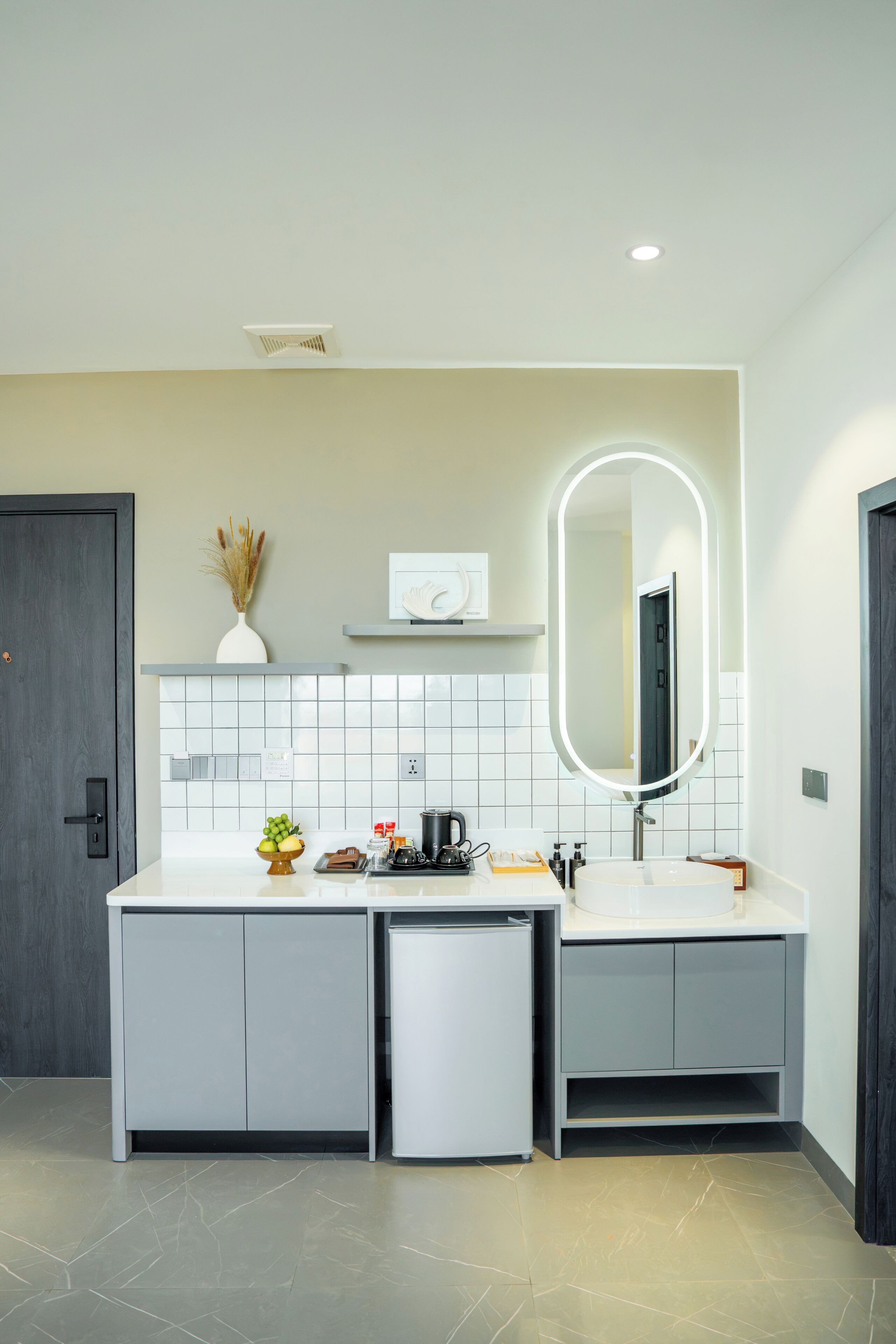 A modern bathroom with a double vanity, a large mirror, and a recessed ceiling light.
