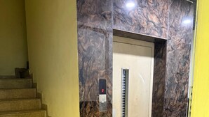 A marble wall, a staircase, and a potted plant. - Charming 9-bedroom hotel with AC in Indore
Fully Air Conditioned Budget Friendly (Indore)
