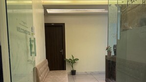 A reception area with a sofa, a door labeled '302', and potted plants. - Charming 9-bedroom hotel with AC in Indore
Fully Air Conditioned Budget Friendly (Indore)