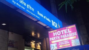 A building with a prominent Bank of India sign, a visible entrance, and a Hotel Paradise sign. - Charming 9-bedroom hotel with AC in Indore
Fully Air Conditioned Budget Friendly (Indore)