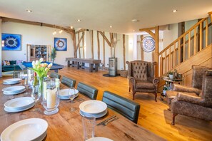 A spacious living area with a wooden floor, a billiards table, and a dartboard. There is a bookshelf and a fireplace. - Wolmers Barn, Stonham Aspal, Suffolk (Stonham Aspal)