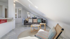 Un loft moderno con techos altos, sala de estar con sofá y mesa de centro, zona de cocina y comedor.