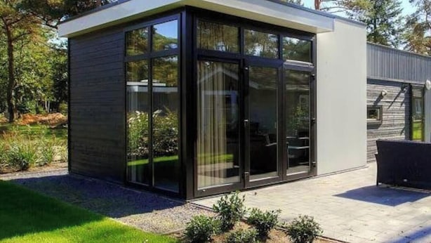 A modern building with large glass windows, a flat roof, and a concrete base. - Holiday Home in Belfeld With Terrace (Belfeld)