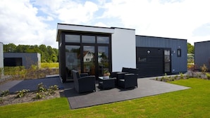 A modern building with a patio area featuring outdoor furniture. - Holiday Home in Belfeld With Terrace (Belfeld)