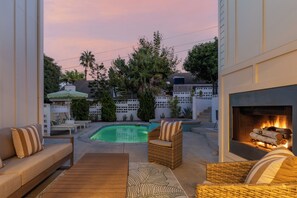A pool area with lounge chairs, a fire pit, and a view of the pool. - Family Beach House w/ Pool & AC + Walking Distance to Shops + Food (Encinitas)