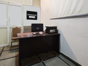 A corner office with a desk, computer, and printer, a chair, and a sign indicating it's a company-serviced townhouse. - Premium Super Townhouse Alwal Road (Hyderabad)