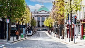 A street leading to a building with a dome, surrounded by trees and shops. - One Capel Suites (Dublin)