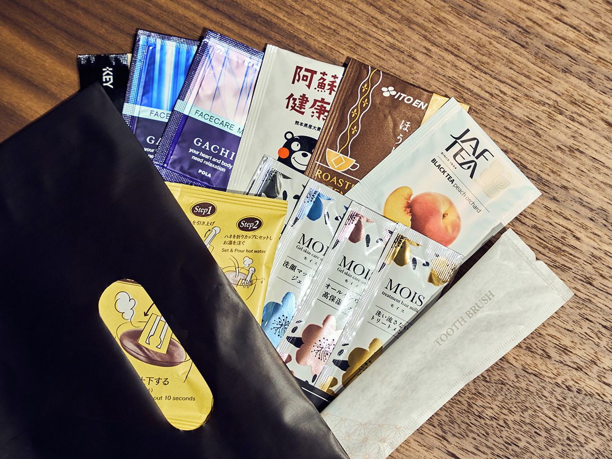 A variety of packaged products including skincare and haircare items, arranged on a wooden surface.