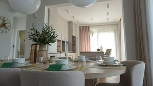 A dining area with a round table, chairs, and a plant centerpiece. - Villa Bella Vista with heated pool (Rovanjska)