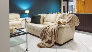 A living room with a sofa, a coffee table, and a bookshelf. - Three bedroom Apartment (Il-Gżira)