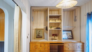 A compact room with a built-in desk, shelving, and a hanging light fixture. - Three bedroom Apartment (Il-Gżira)