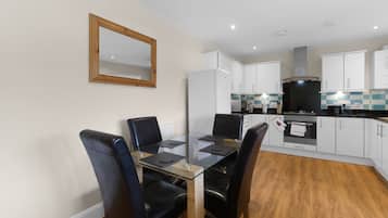Family Apartment, Balcony | Private kitchen | Toaster, cleaning supplies, freezer, dining tables