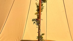 A tent with a bed, pillows, and a blanket. - Daisys Meadow Retreat Sleeps 2 With Hot Tub (Ashford)