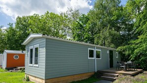 A small, single-story mobile home with a front porch and a small deck. - Holiday Home in Amstelveen With Terrace (Amstelveen)