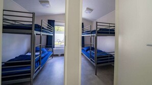 A room with bunk beds, a window with curtains, and a radiator. - Holiday Home in Amstelveen With Terrace (Amstelveen)